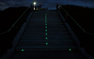 千葉県長生村の築山公園型津波避難場所で公園頂上へ誘導する暗視下のハイブリッドストーン アベイラス アルシオール ステップ（高輝度蓄光式防滑階段材）を下から見た様子
