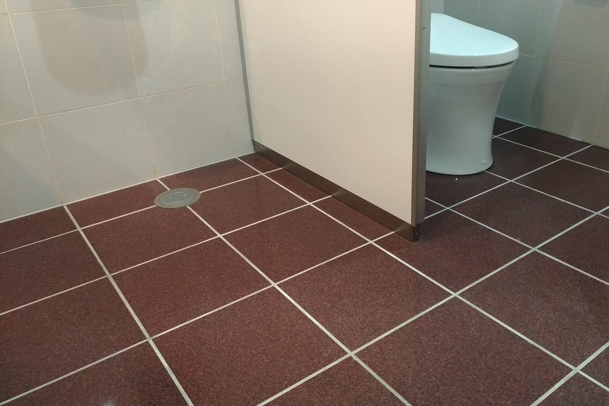 トイレの床に施工したハイブリッドストーン アベイラス ポリッシュ レッド色